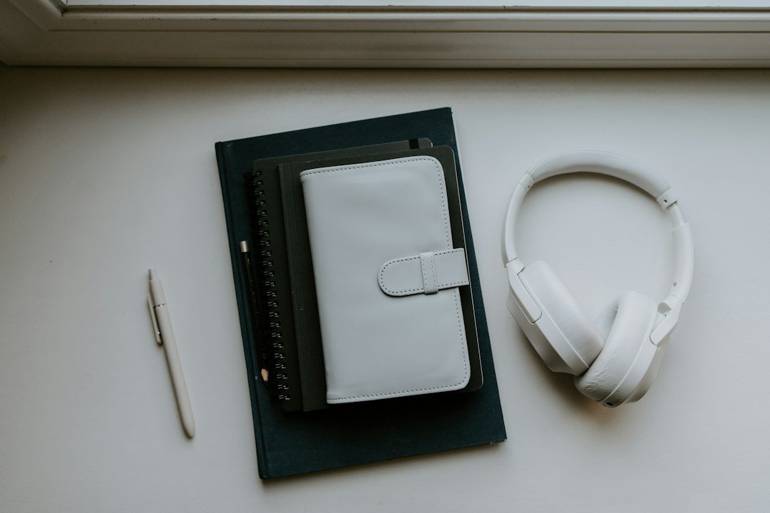 Books, notebook, pencil and headphones representing an analog bag and screen-free hobbies