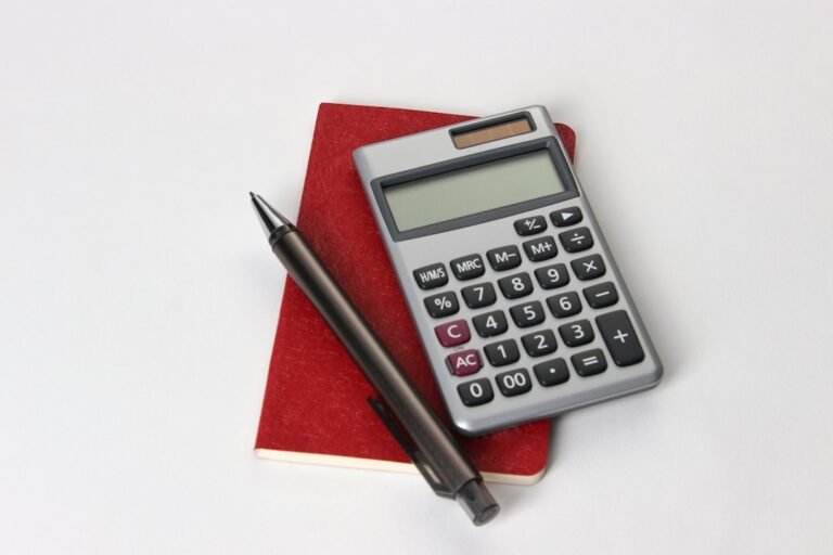 Calculator, notebook and office supplies illustrating budgeting and moneymaxxing