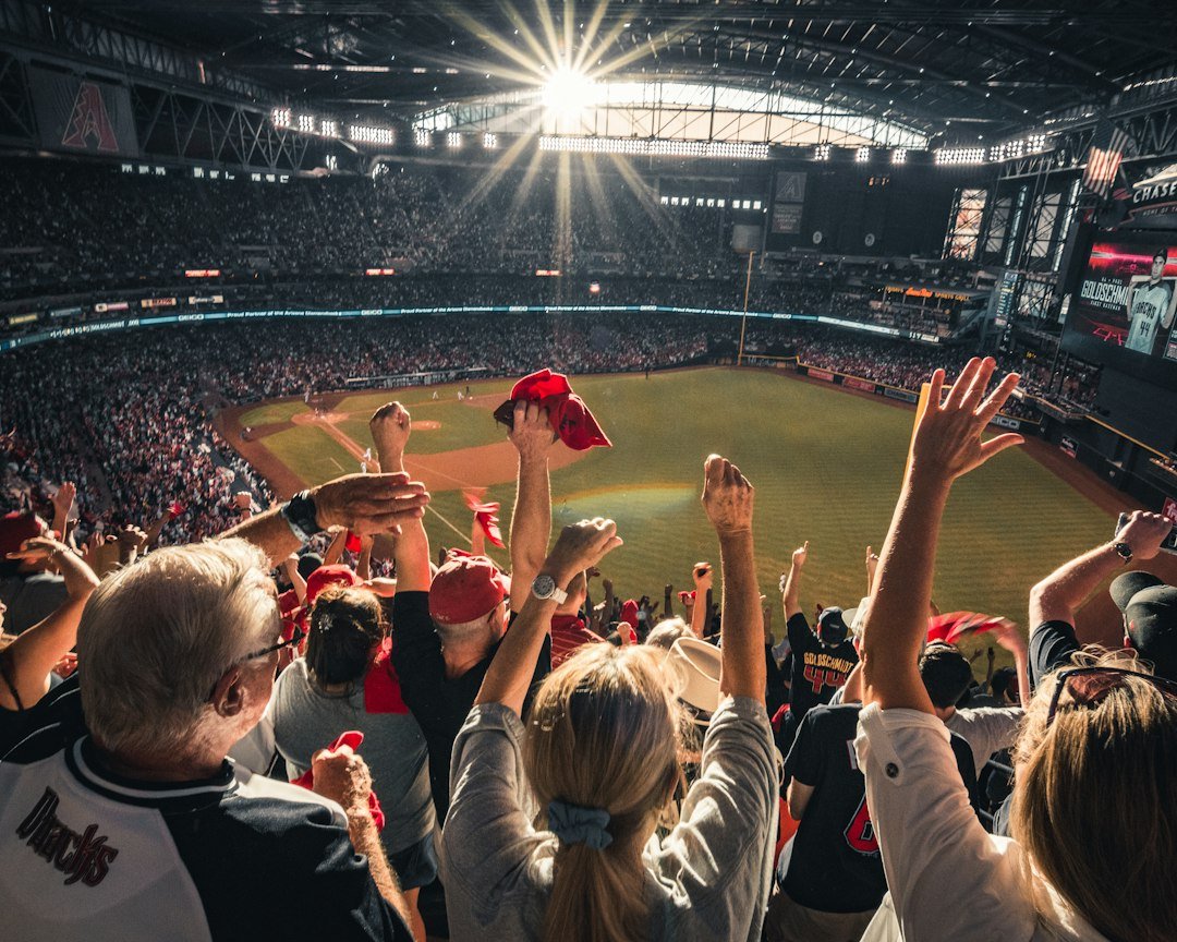Fans celebrating at a stadium, illustrating sports tourism and travel built around live events