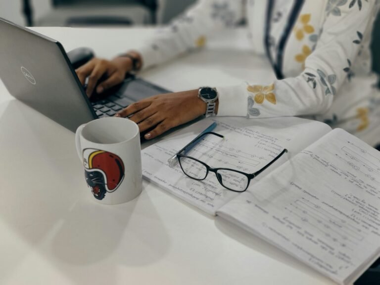 Student studying research papers at a desk