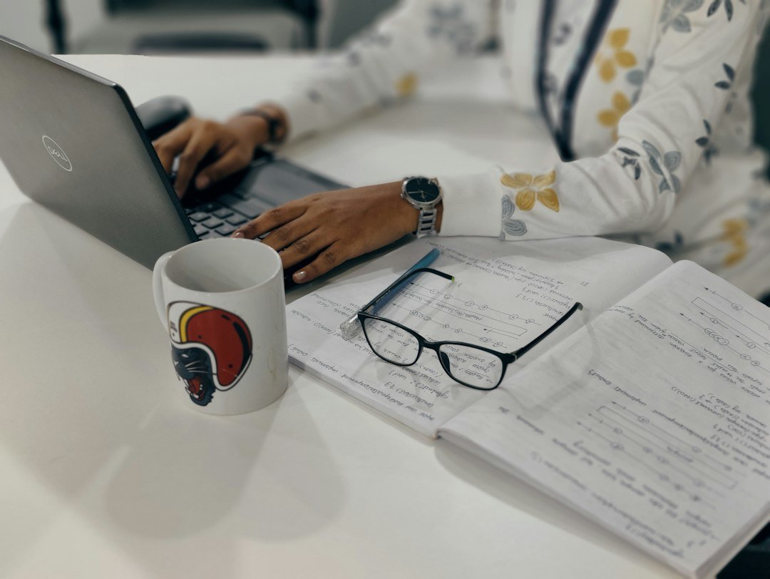Student studying research papers at a desk