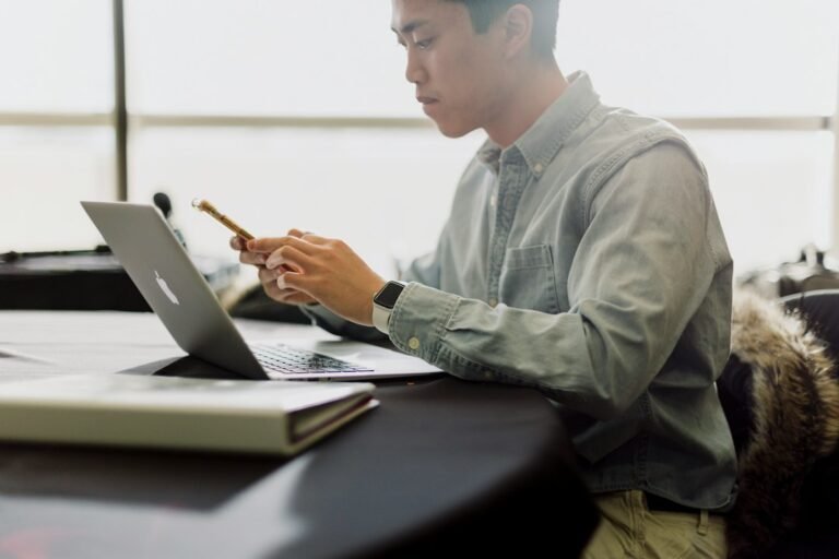 Person working with a laptop, illustrating independent thinking alongside AI assistance