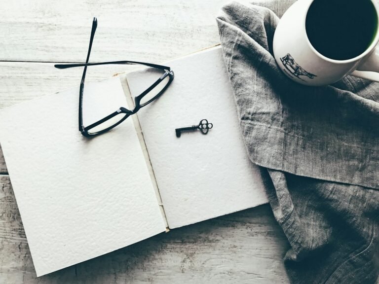 Eyeglasses and an old key on a book, illustrating everyday misplaced objects and memory