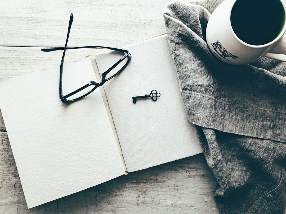 Eyeglasses and an old key on a book, illustrating everyday misplaced objects and memory